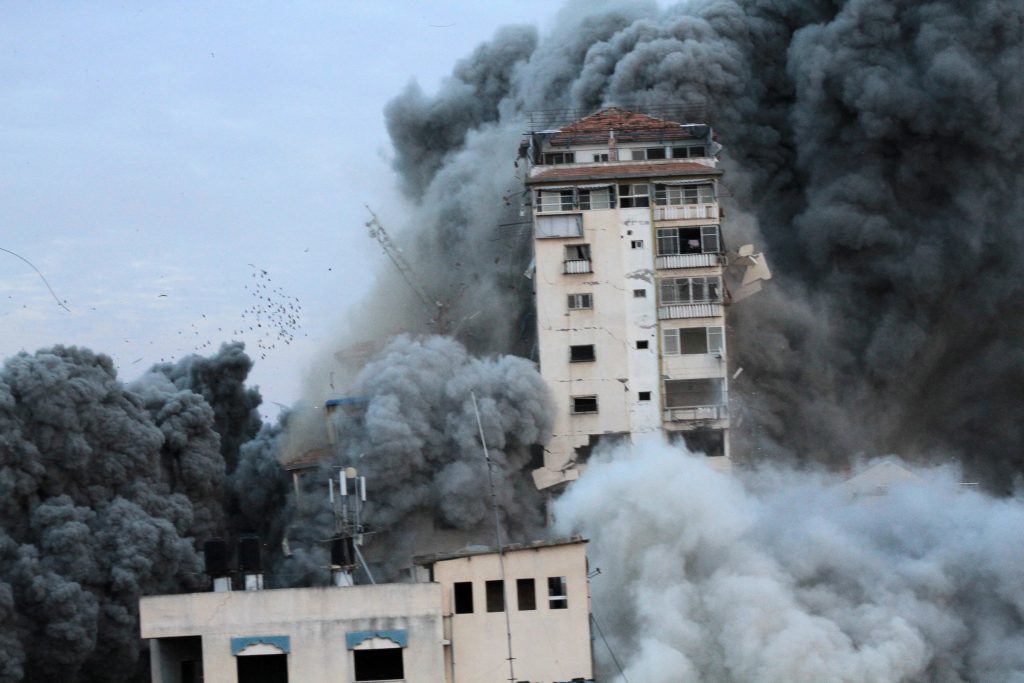 Smoke billows around a tower in Gaza City following a detention