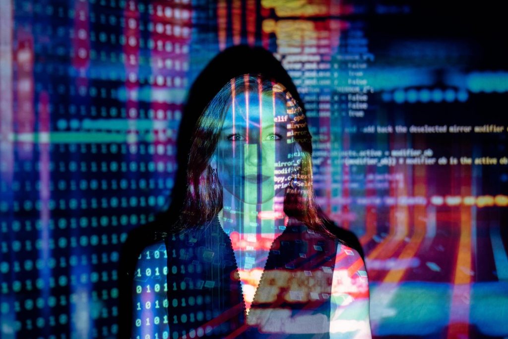 A woman with a colourful projection of numerical code on her Digital self-determination, privacy, digital, online, data, personal information, data rights