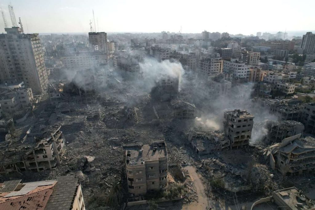 Devastation and destruction in Gaza. Shattered buildings stand among the rubble of buildings which have collapsed. Smoke drifts across the scene. Is the ICC biased?