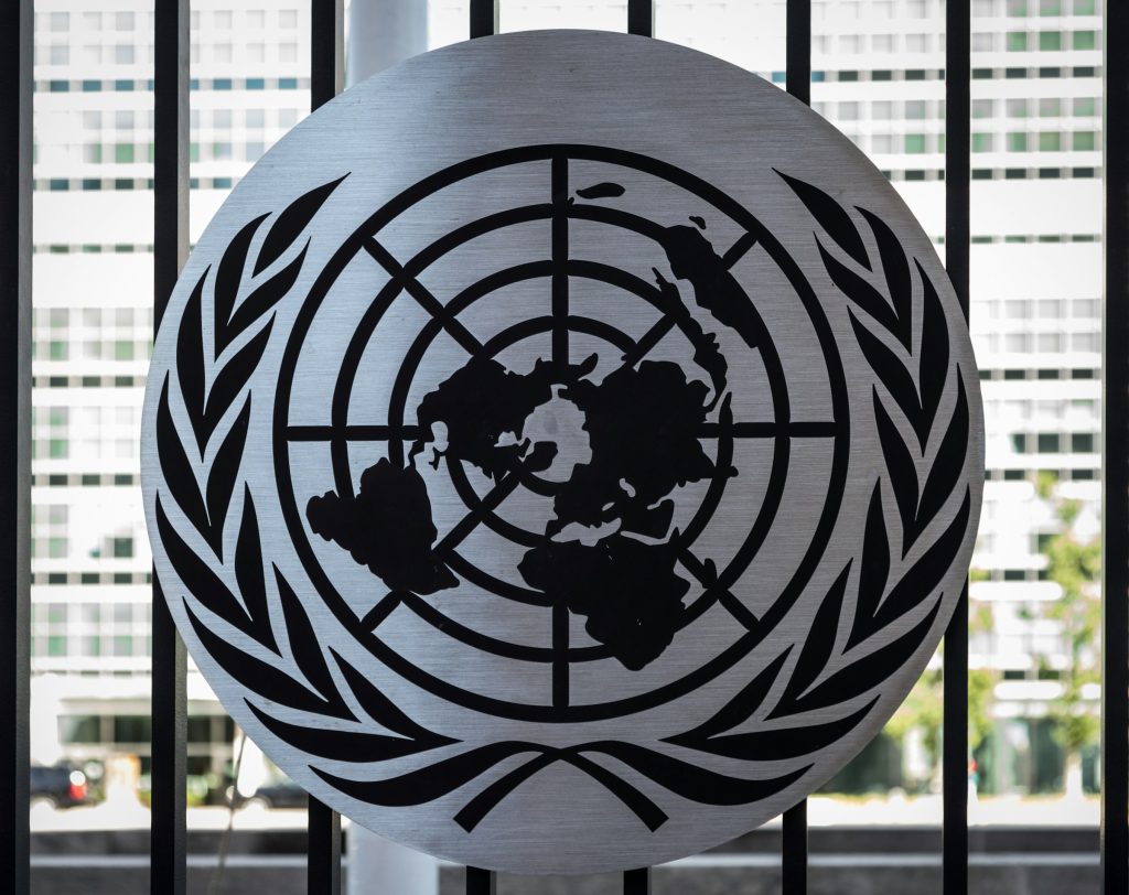 The United Nations emblem on display in front of a window