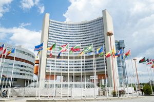 A large building with many flags in front of it