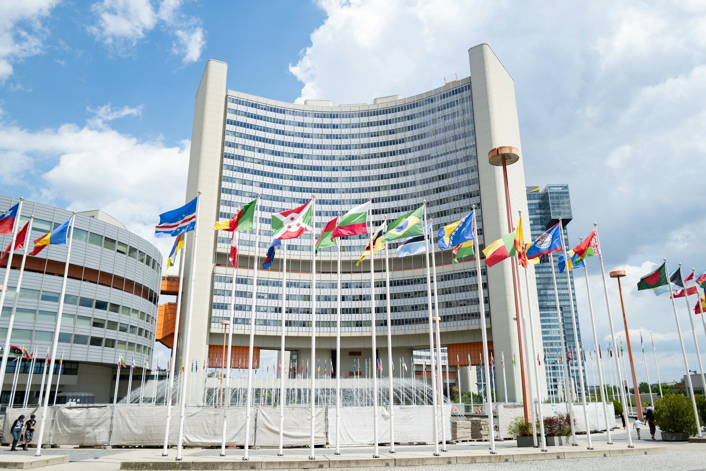 A large building with many flags in front of it
